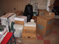 5/17/2005: I had to build a jail out of dead computers and cardbord boxes in Carol's mom's basement to keep the incontinent little devil from making messes while I worked on the computer a few feet away. He's quite the jumper and was very good at getting out.